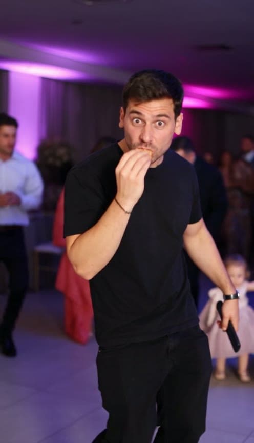 Bby Wow Guy AI reference: a party dancer takes a concha bite and looks at the camera